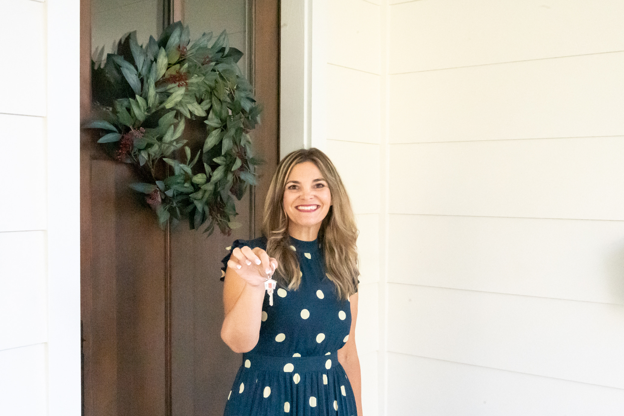 Kellie Ortiz smiling with house keys